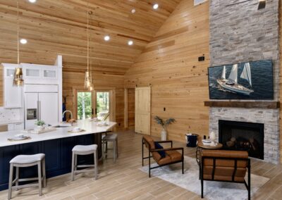 Rustic living area with kitchen and fireplace.