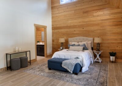 Cozy bedroom with wooden walls and modern decor.