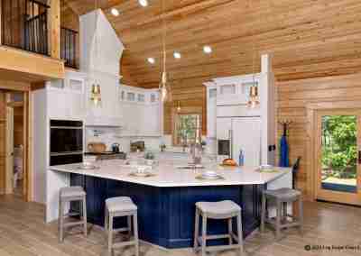 Rustic kitchen with modern white cabinetry and island.