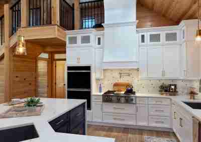 Modern kitchen with white cabinets and wooden accents.