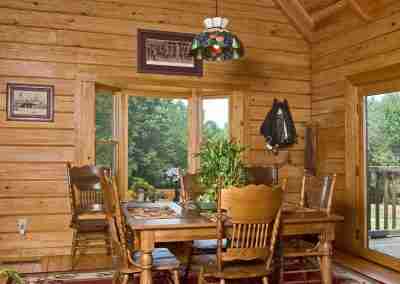 Cozy wooden dining room with natural lighting.