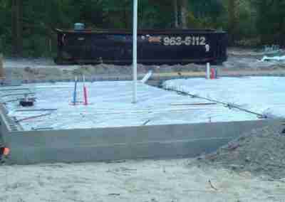 Construction site with concrete foundation and tools.