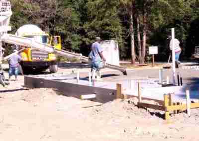 Workers pouring concrete on a construction site.