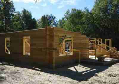Newly constructed wooden house in forested area.