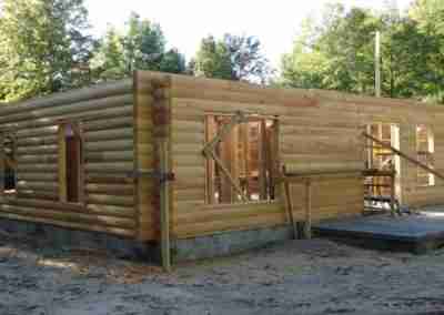 Construction of a log cabin house frame.