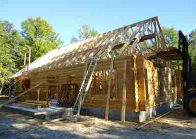 Construction of a wooden cabin with scaffolding.