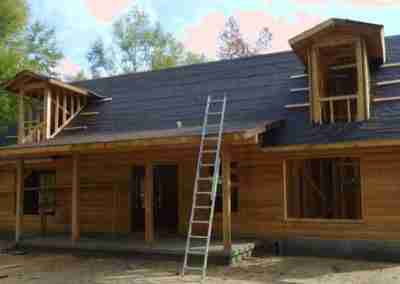Newly constructed wooden house with scaffolding.
