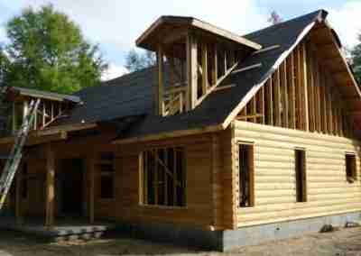 Under construction wooden cabin in a forest.