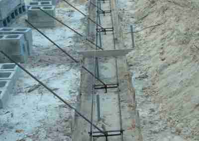 Construction site with concrete blocks and rebar.