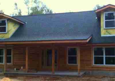 Rustic wooden house with unfinished exterior details.
