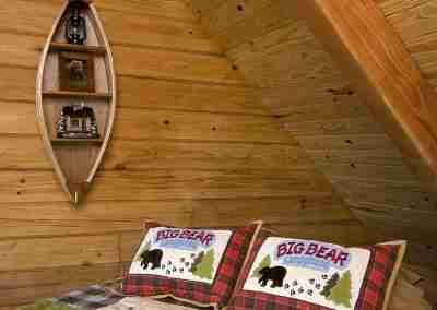Cozy cabin bedroom with bear-themed decor.
