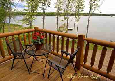 Scenic lake view from a wooden deck.