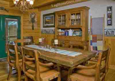 Rustic dining room with wooden furniture and decor.