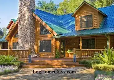 Beautiful log cabin with stone chimney and greenery