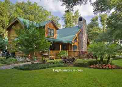 Cozy log cabin with landscaped yard and porch