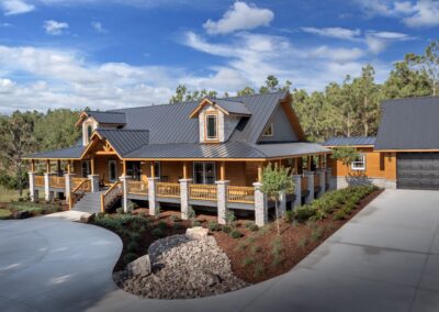 Spacious cabin with wraparound porch and metal roof.