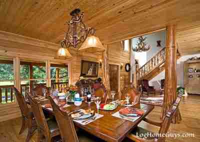 Rustic dining room with wooden decor and chandelier.