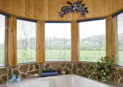 Cozy spa area with wooden decor and windows.